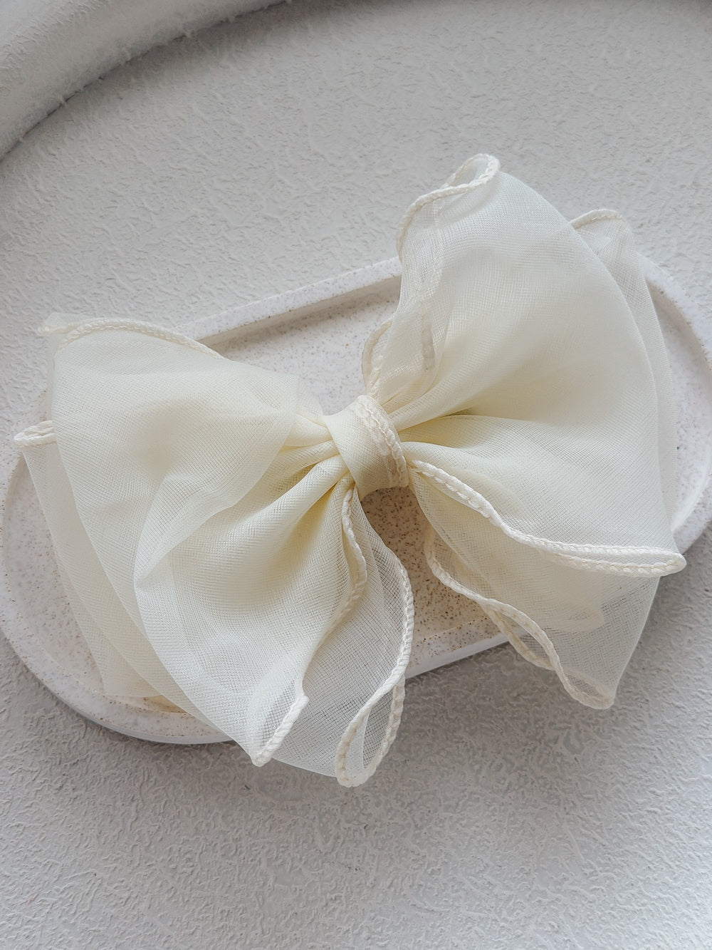 Wavy Girls Ivory Bow with soft curved shape on white background