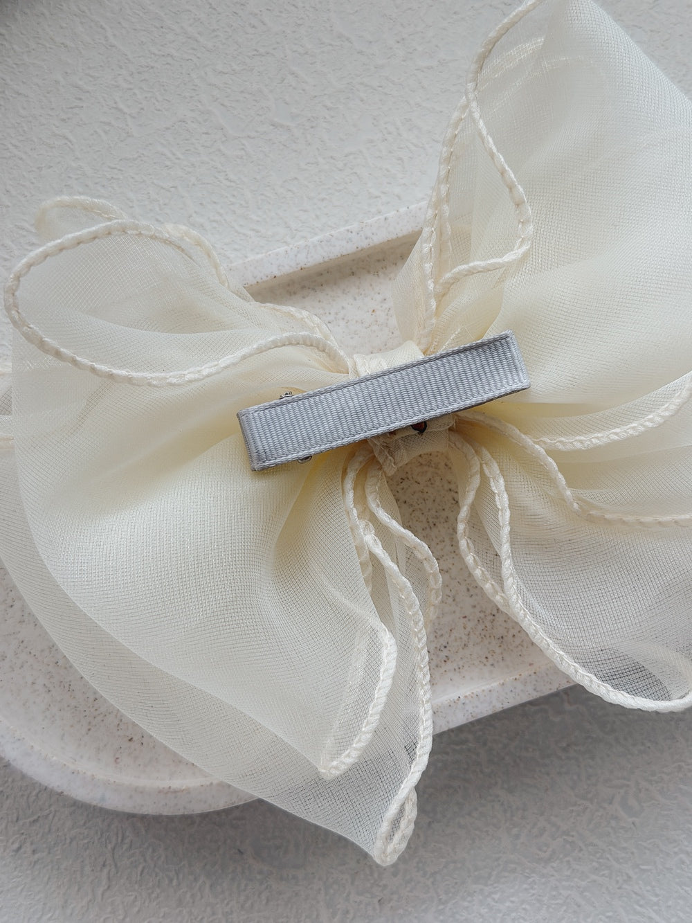 Elegant ivory wavy bow accessory for weddings and Communions