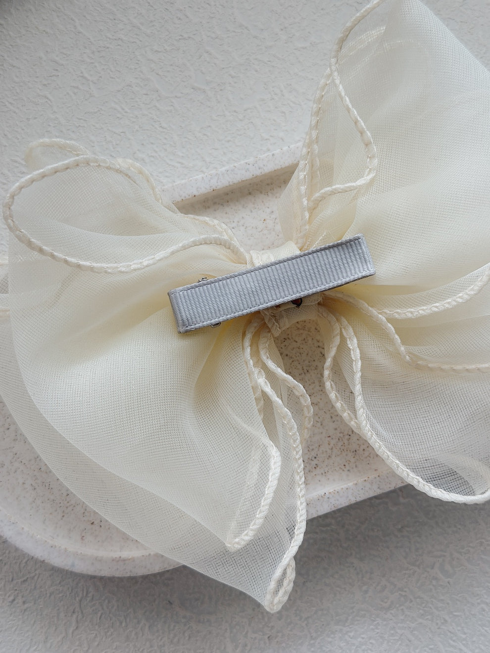 Elegant ivory wavy bow accessory for weddings and Communions