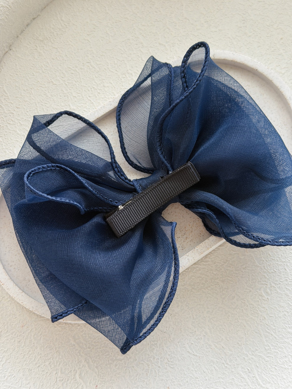 Navy wavy bow on alligator clip – ideal for flower girl outfits and birthday looks