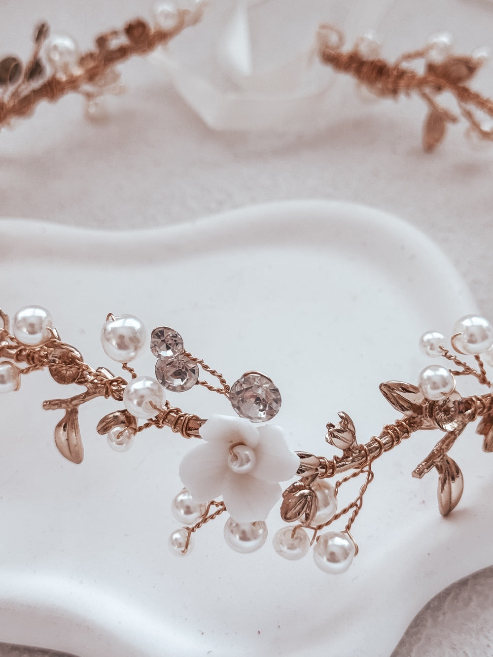 Elegant gold headpiece with pearls and porcelain flowers for weddings