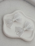 White ribbon bows with stitched edging