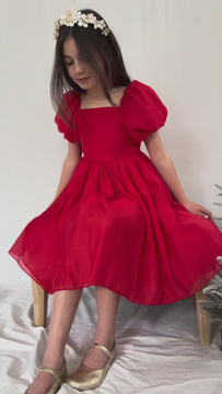 Girl twirling Lucy girls red puff sleeve christmas dress 