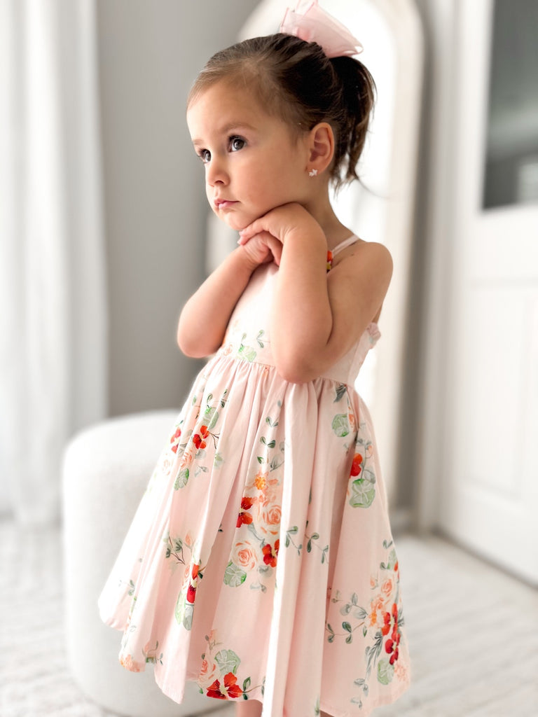 Vdieo of the Marley Girls Floral Christmas Dress featuring adjustable button straps and a charming frill detail across the back, perfect for summer.
