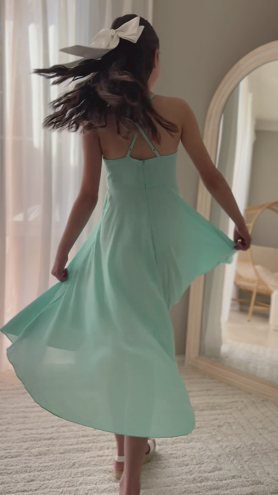 Girl twirling in year 6 turquoise graduation dress