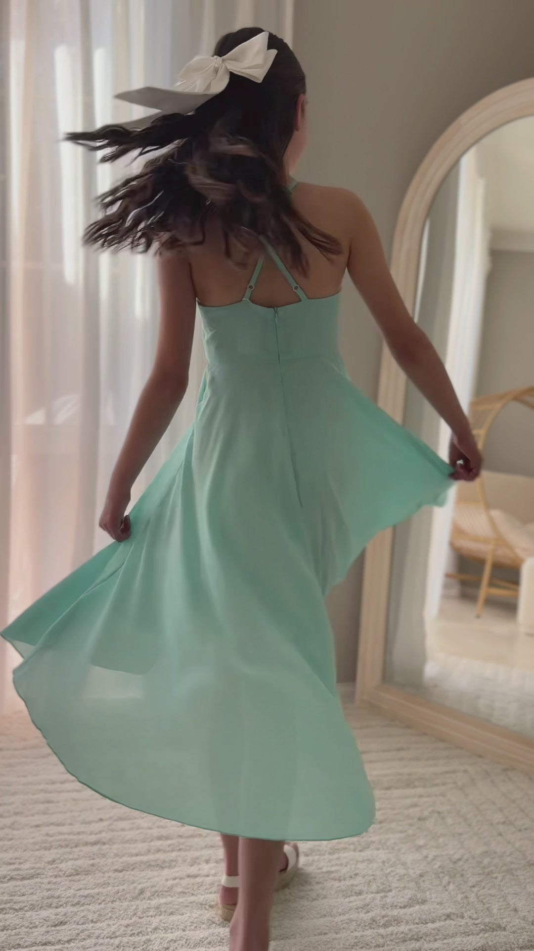 Girl twirling in year 6 turquoise graduation dress