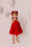 Girl holding her red dress while wearing the Winterberry flower crown against a star backdrop