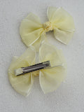 Soft pastel yellow pigtail bows