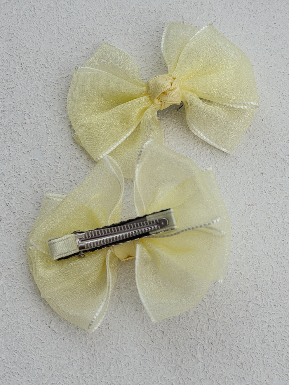 Soft pastel yellow pigtail bows